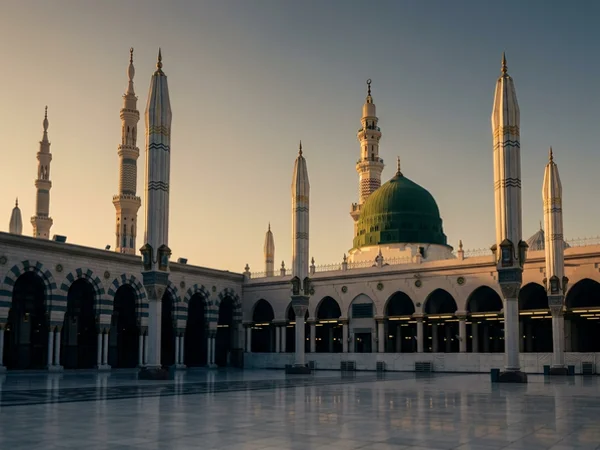 Green dome of the Prophet's Mosque in Madinah at sunrise