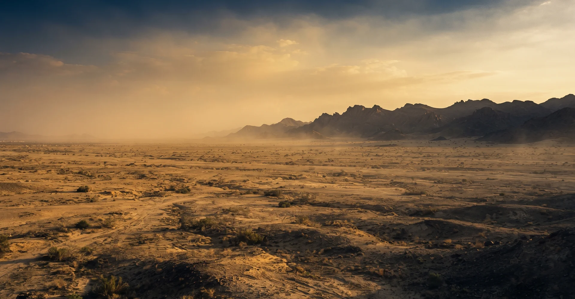 The plain of Arafat at golden hour with a distant ridge and warm haze