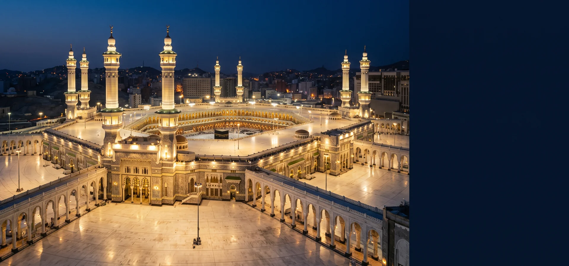 Aerial view of the illuminated Masjid al-Haram courtyard at blue hour